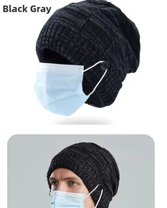 Detail view of dark grey knit beanie featuring buttons for securing face mask straps