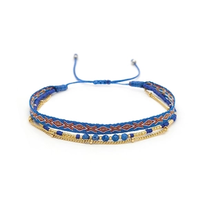 Detail view of multilayer Miyuki bead bracelets with geometric woven band and gold chain