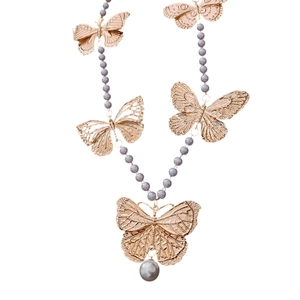 Vintage butterfly pearl necklace with blue beads and gold metal accents on white background