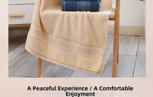 Close-up of thick cream cotton bath towel with stripe details on a wooden chair