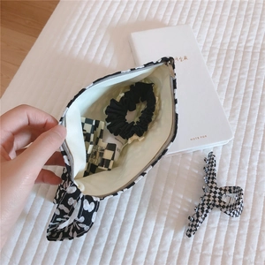 Floral mini cotton pouch showing inner storage for hair ties and cosmetics