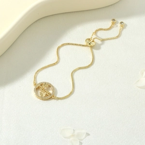 Detailed view of gold Mama heart bracelet with sparkling zircon accents and adjustable chain