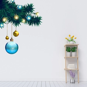Wall decal of Christmas pine branch with gold and blue ornaments on a white wall decor