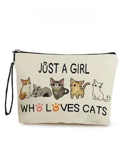 Detail of canvas cat makeup bag with 'JUST A GIRL WHO LOVES CATS' print and wrist strap