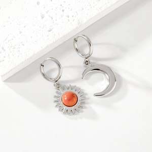 Asymmetric sun and moon earrings in silver stainless steel with orange bead detail