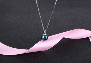 Detail shot of iridescent deep purple pearl pendant with S925 silver chain and hallmark