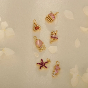 Set of 6 gold ocean animal pendants with pink and purple zircon stones and rhinestones