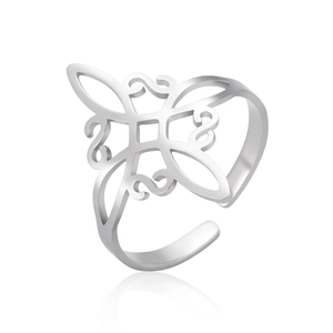 Detailed view of polished stainless steel open ring with intricate cutout knot pattern