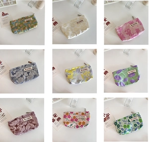 Detail view of various floral and geometric patterns on zippered cosmetic storage bags