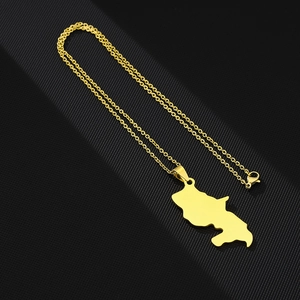 Macro shot of gold Martinique map pendant necklace with a lobster clasp closure