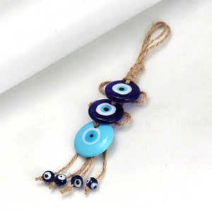 Detailed close-up of Evil Eye keychain with blue resin beads and braided hemp rope