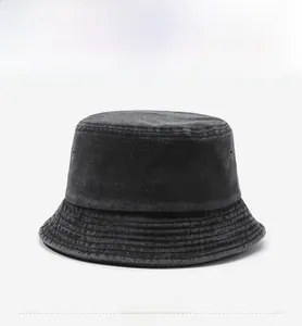 Close-up of black washed denim bucket hat with reinforced stitching and metal eyelets