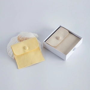 Detail of luxury yellow velvet pouch and gift box with minimalist shell decoration