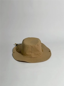 Detail of khaki outdoor sun hat with adjustable chin strap and metal side buttons
