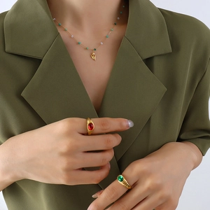Elegant gold tulip pendant necklace with crystal beads shown on female model