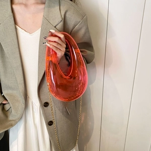 Chic orange acrylic candy-colored evening bag with curved handle and gold chain strap