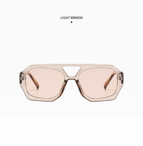Detail shot of light brown geometric hexagonal sunglasses with translucent frames