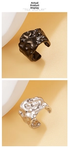 Macro detail of vintage hammered texture ear cuffs in polished silver and matte black