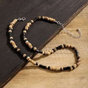 Bohemian style coconut wood bead necklace with alternating brown and black cylindrical beads