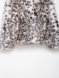 Close-up of leopard print faux fur jacket showing high-quality plush texture and hem detail