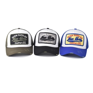 Distressed 3D New York embroidered trucker hats with mesh back in green, black, and blue