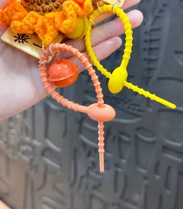 Flexible PVC soft glue keychain strap with a colorful bell and knitted sunflower charm.