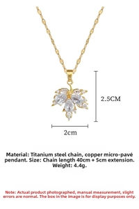 Detail view of gold maple leaf pendant with pavé crystals and size specifications