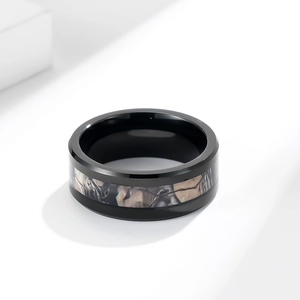 Men's matte black tungsten carbide ring with camouflage inlay on white background