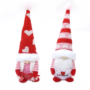 Handmade Valentine's and Mother's Day gnomes with knitted hats holding heart signs