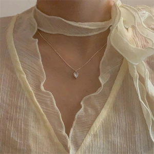Close-up of S925 sterling silver heart necklace with white zircon on neck