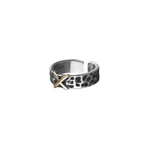 Detailed macro view of S925 hallmark on vintage silver ring with gold X accent