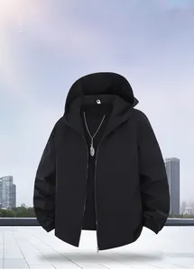Detail of black hooded jacket featuring windproof texture and silver feather necklace