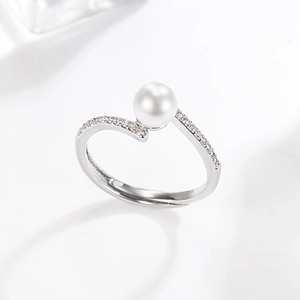 Elegant 14k gold pearl ring with diamond accents and adjustable crossover silver band