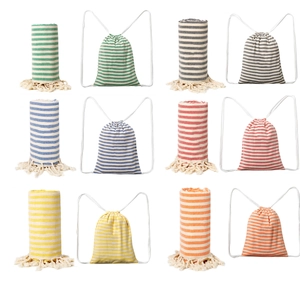 Close-up showing six colorful striped cotton beach towels with matching drawstring backpacks