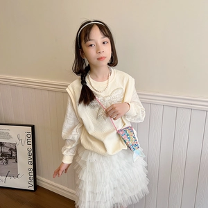 Cute girls knit vest with silver sequin bow, white tutu skirt, and colorful mermaid bag