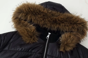 Close-up of black padded coat with detachable brown faux fur collar and metal zipper