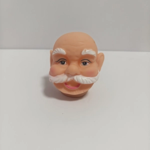 Macro shot of 3D vinyl Santa Claus head figurine for DIY Christmas ornaments
