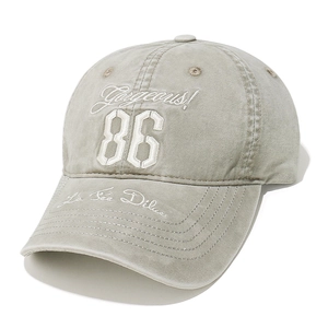 Close-up of Gorgeous 86 3D embroidery on washed khaki vintage baseball cap