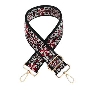 Close-up of ethnic jacquard purse strap with embroidery and golden metal hardware