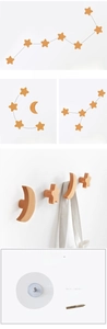 Detail of wooden star and moon wall hooks with mounting accessories for easy installation