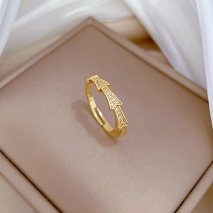 Macro shot of gold bamboo zircon ring showing intricate pave stones and adjustable band