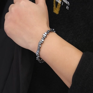 Close-up of adjustable handmade bracelet with irregular hematite beads on wrist