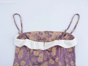 Detail view of purple jacquard dress back with golden floral pattern and invisible zipper