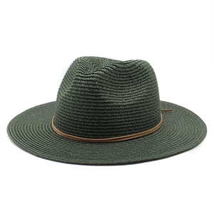 Detailed weave texture of dark green straw fedora hat with brown leather band accent