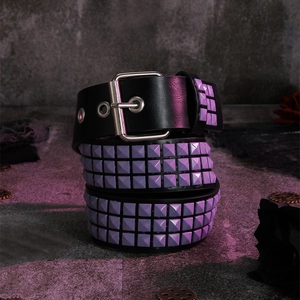 Detail of punk black leather belt with multiple rows of purple pyramid metal studs