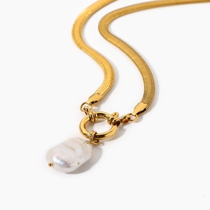 Detail of 18K gold snake chain necklace with an irregular baroque pearl pendant