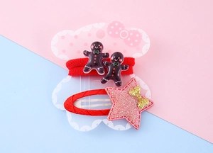 Detail of red Christmas hair ties with gingerbread man and glitter star hair clip set