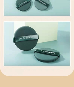 Close-up of green round air cushion puffs with I'm Pineapple text for BB cream