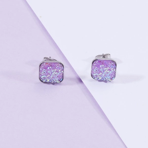 Detailed view of square stud earrings with purple gradient glitter and silver base
