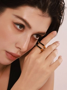 Close-up of 18K gold plated stainless steel square ring on model with black acrylic inlay